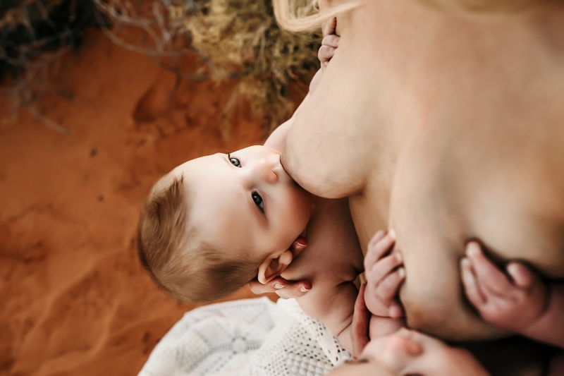 Motherhood Photographer, mother breastfeeds two twin babies