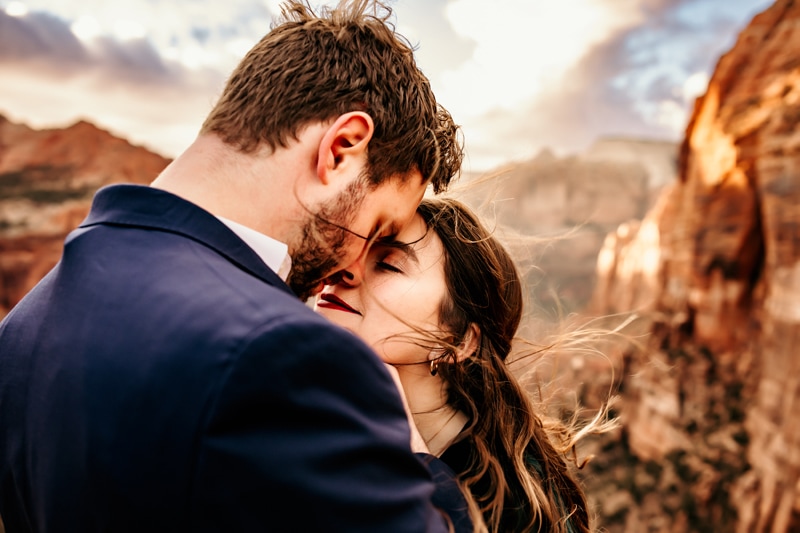 Vacation Photographer, man and woman warmly embrace face to face outdoors