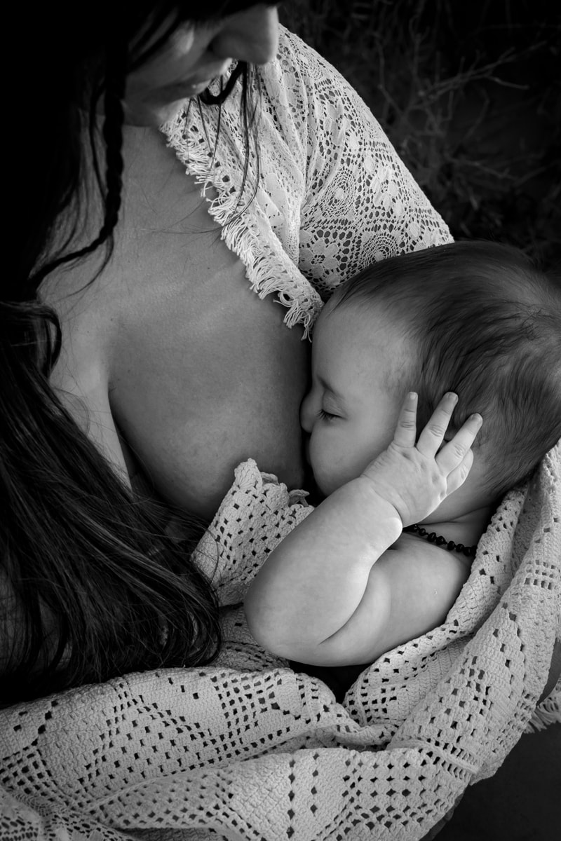 Motherhood Photographer, Mom breastfeeds newborn baby