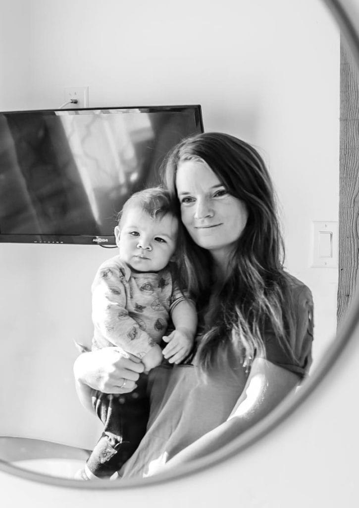 In a mirror's reflection, Family Photographer Sarah holds her baby boy