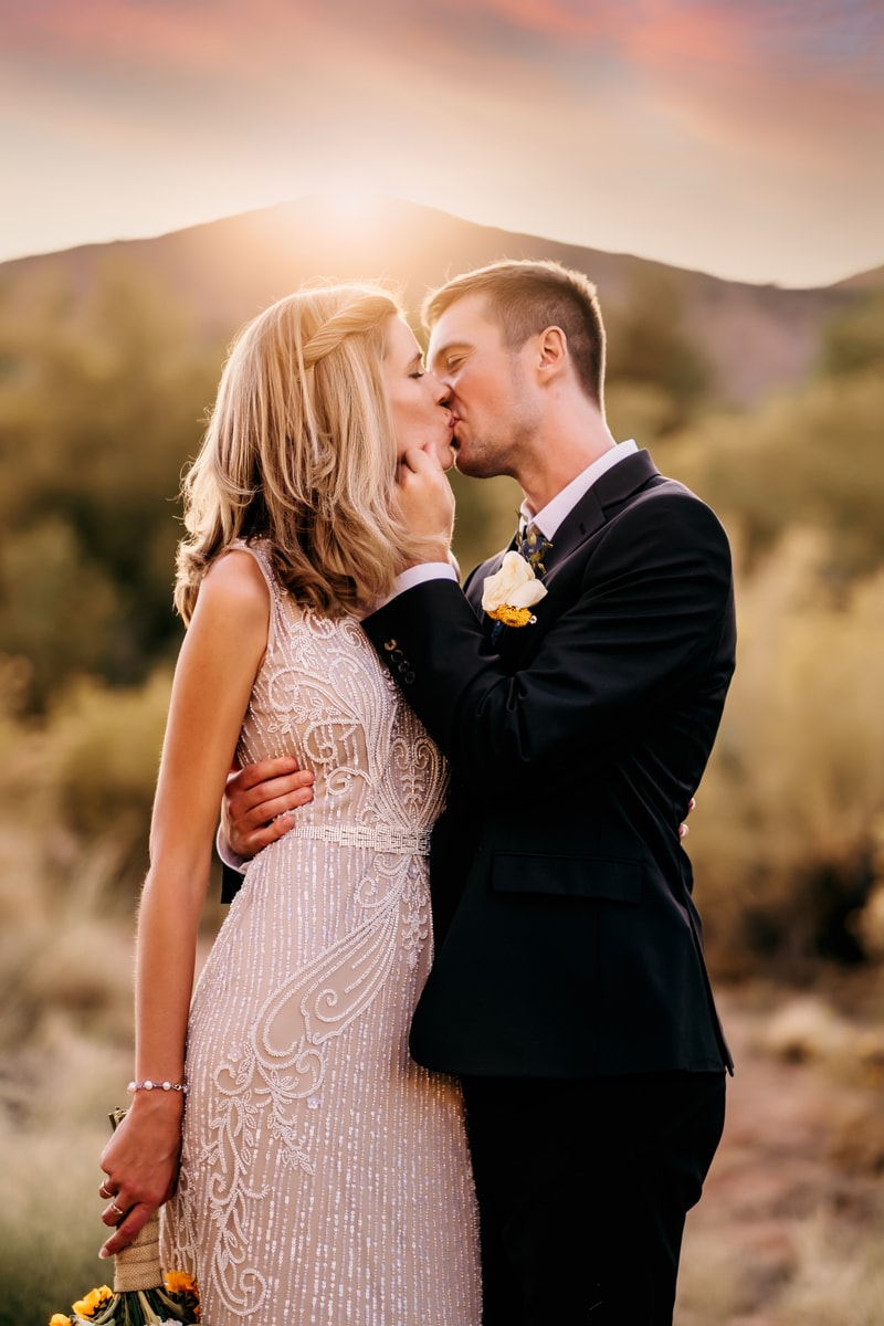 Elopement Photographer, a bride and groom embrace and kiss outside