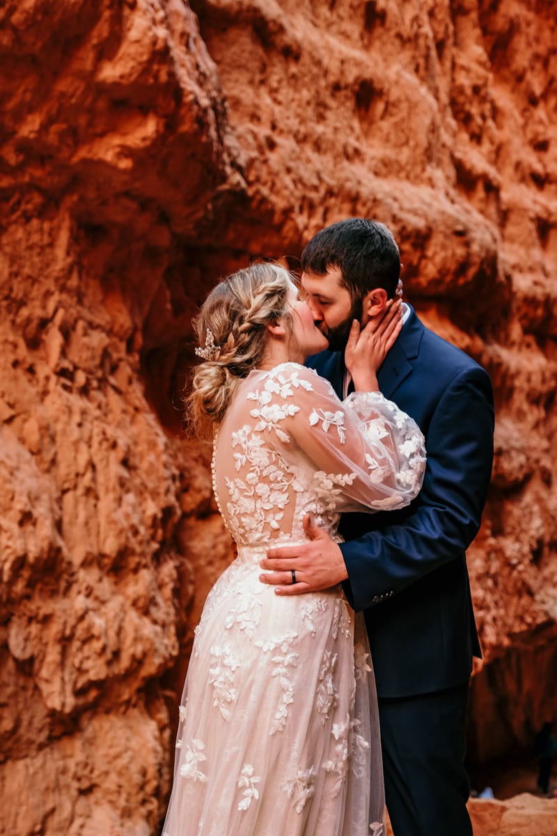 Elopement Photographer, Bride and groom kiss in Utah canyons