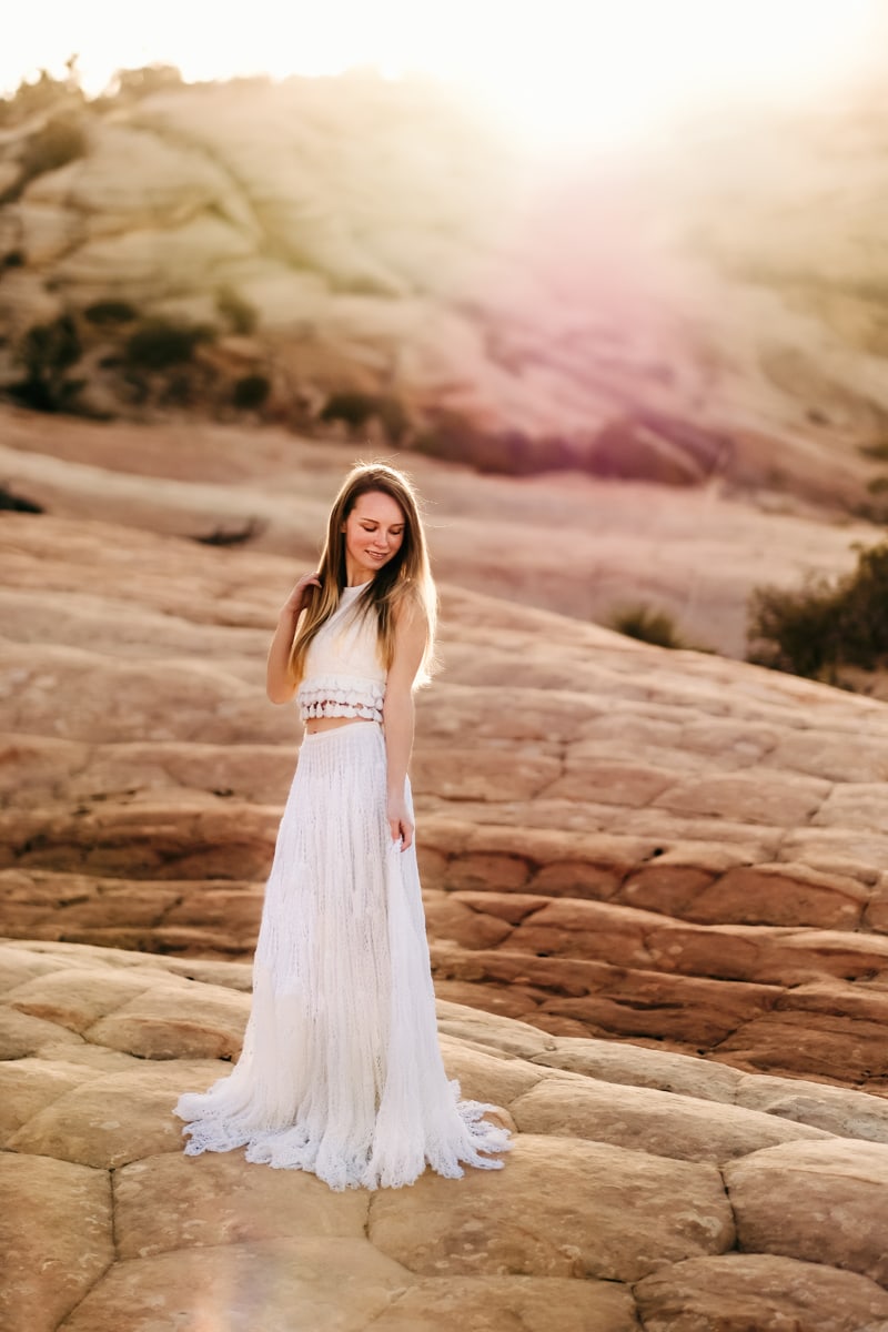 Elopement Photographer, a bride stands in Utah Wilderness wearing her wedding dress