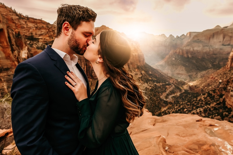Elopement Photographer, husband and wife kiss before Zion National Park at Sunset