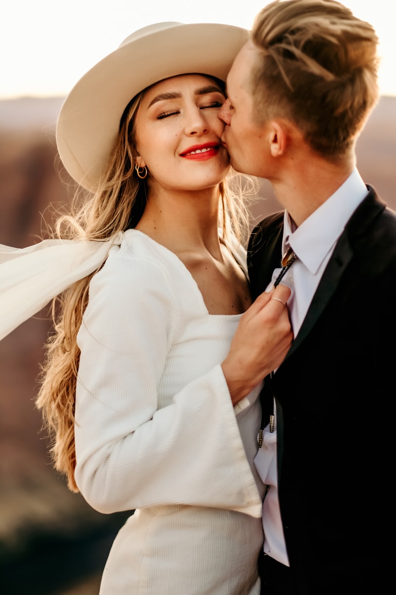 Elopement Photographer, a groom kisses his bride