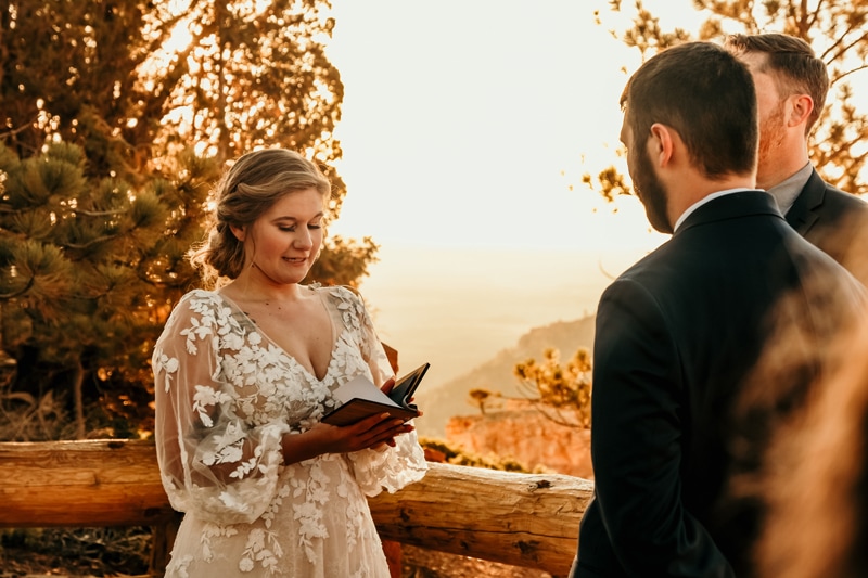 Elopement Photographer, a bride reads her vows before her husband to be and officiant