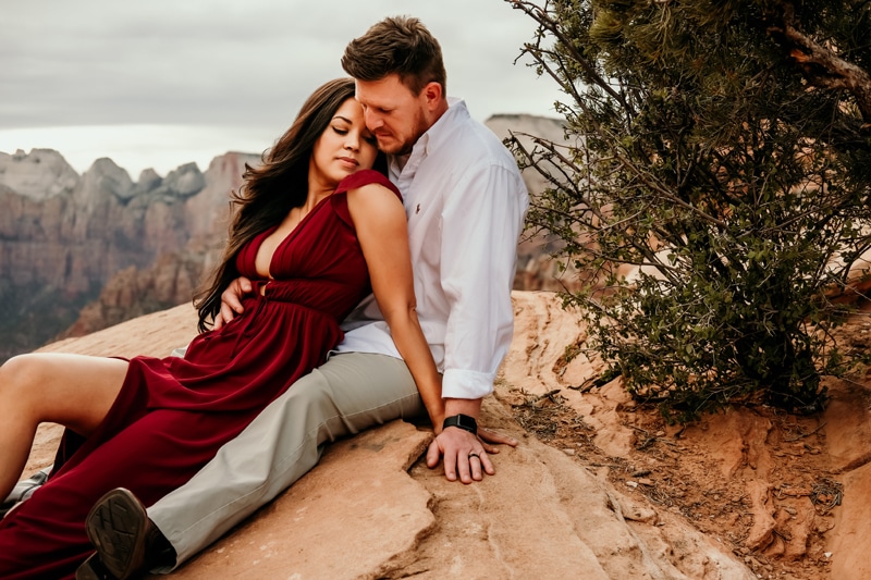 Vacation Photographer, a woman leans into her husbands lap in Zion