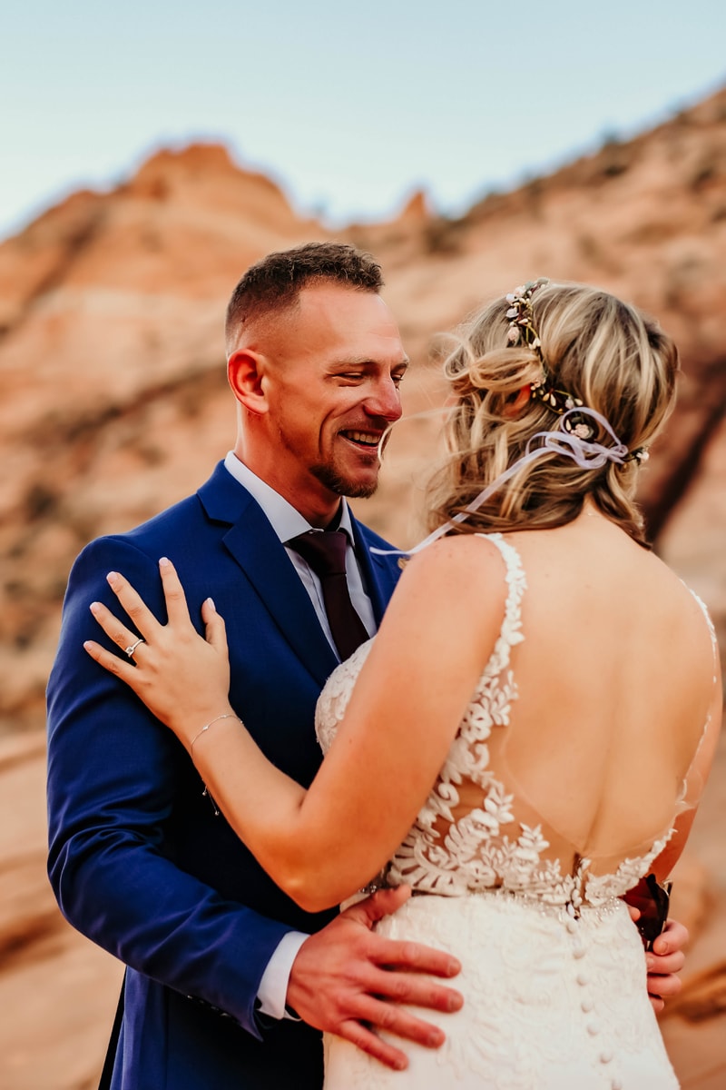 Elopement Photographer, a couple gaze into each other's eyes, she wears her wedding dress