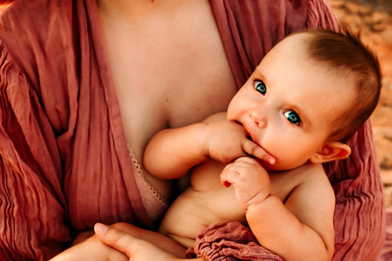 Motherhood Photographer, mother holds baby close to her chest